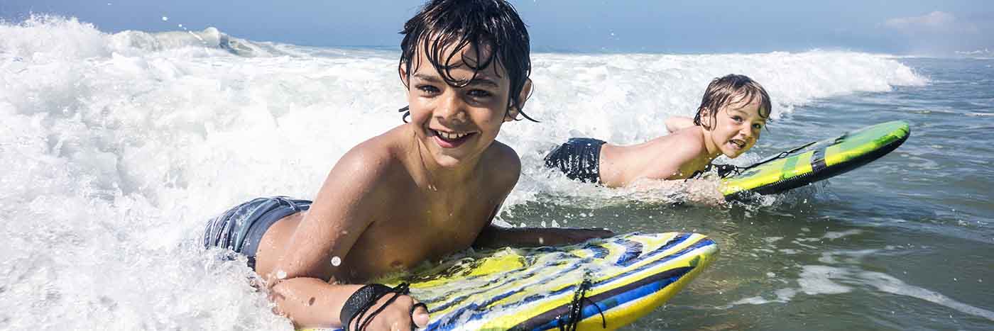 Kids riding the waves at Kure Beach