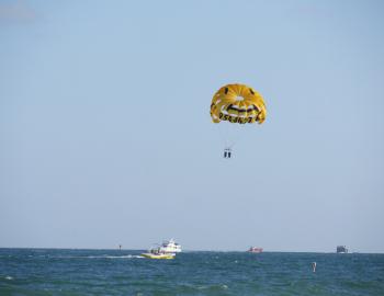 people parasailing off a boat