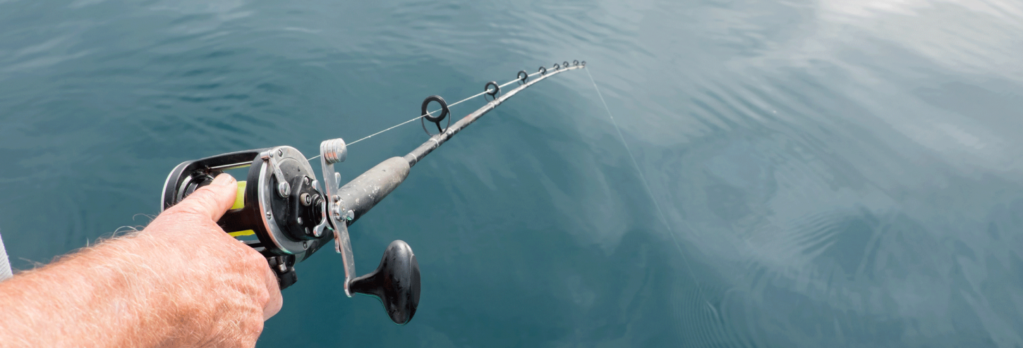 arm holding a fishing rod on a fishing charter boat