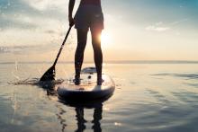 A man paddle-boards on the water