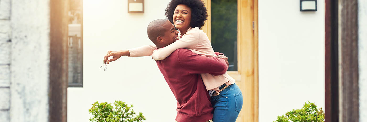 Happy homeowners moving into their new home