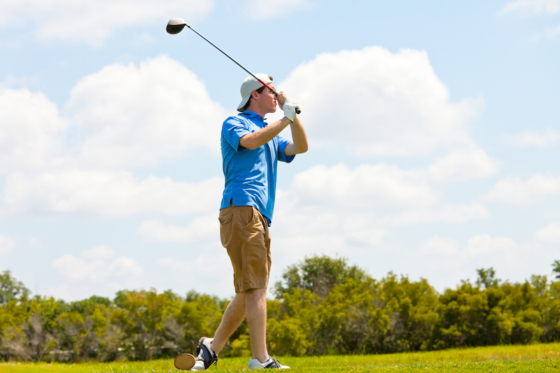 Teen swinging a golf club