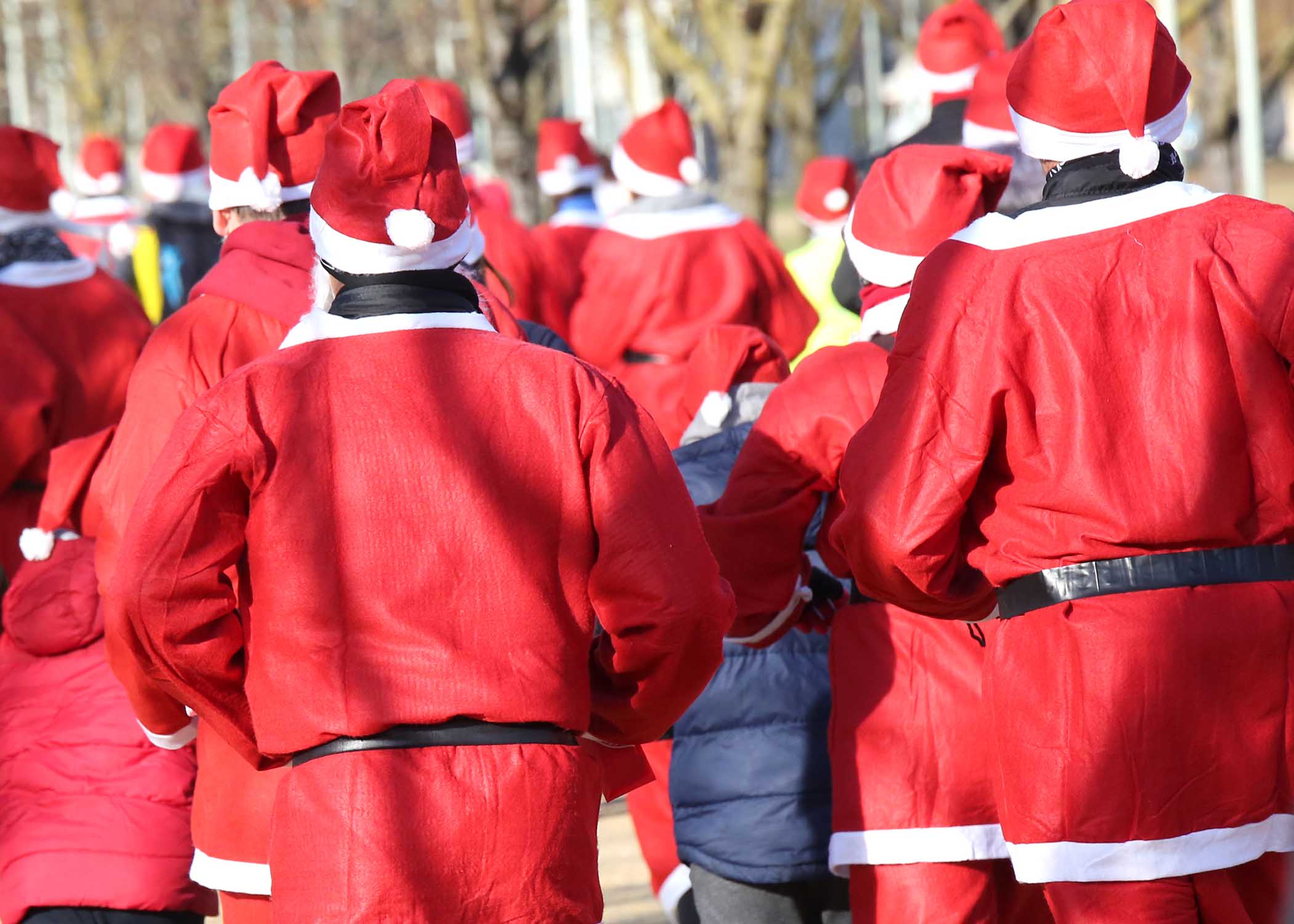 People dressed as Santa racing